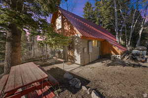 View of home's exterior featuring metal roof and concrete block siding