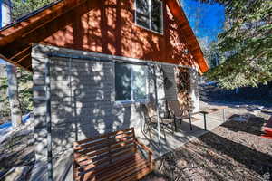 Back of property featuring brick siding and a patio area