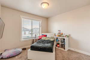 Carpeted bedroom with baseboards