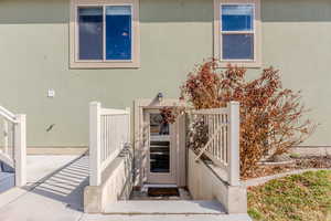 View of exterior entry with stucco siding