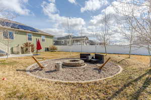 View of yard featuring a patio area, an outdoor fire pit, and a fenced backyard