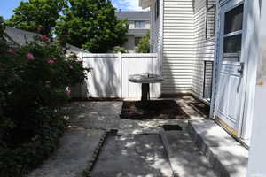 View of patio featuring fence