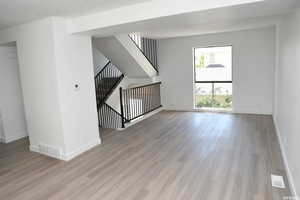 Interior space featuring wood finished floors, visible vents, and baseboards