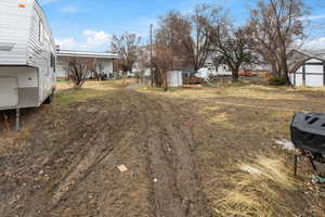 View of yard featuring an outbuilding and a storage shed