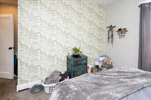 Bedroom featuring carpet flooring and wallpapered walls