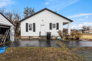 Rear view of house with entry steps and a patio area