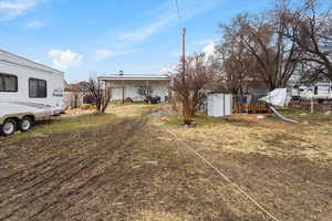 View of yard featuring an outdoor structure and a shed