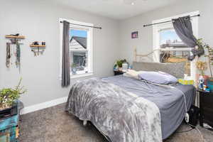 Bedroom featuring carpet and baseboards