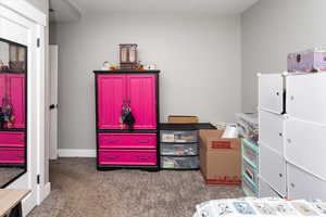 Bedroom with baseboards and carpet flooring