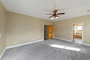 Spare room featuring a ceiling fan, baseboards, and carpet flooring