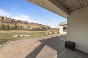 View of yard with a patio, a fenced backyard, and a mountain view