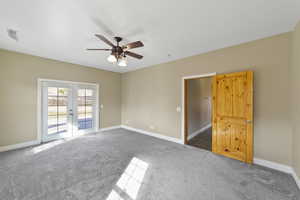 Empty room with french doors, carpet flooring, visible vents, and baseboards