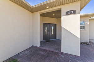 Property entrance featuring stucco siding