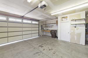 Garage featuring a garage door opener