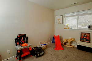 Bedroom with carpet floors, baseboards, and visible vents