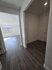 Corridor with dark wood finished floors and baseboards