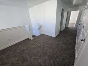 Unfurnished room with carpet floors and baseboards