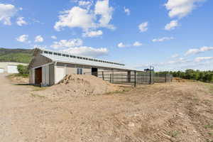 View of horse barn and round pen