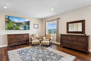 Sitting room featuring dark wood finished floors, baseboards, and recessed lighting