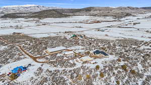 Aerial view of house, outbuildings, barn, arena and turnout areas from northeast