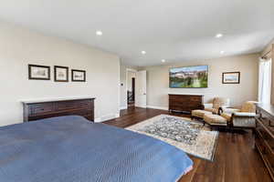 Bedroom featuring dark wood-style floors, recessed lighting, and baseboards