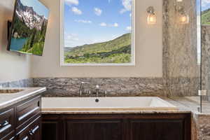 Full bathroom with a bath and vanity