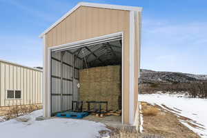 Hay barn with rollup doors on each end.