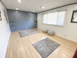 Foyer entrance featuring an accent wall, baseboards, wood finished floors, and recessed lighting