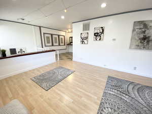 Interior space with baseboards, visible vents, and wood finished floors