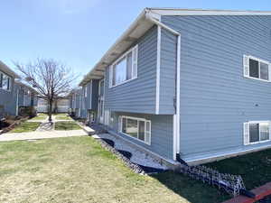 View of side of home with a lawn