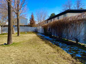 View of yard featuring fence