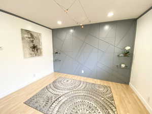 Empty room featuring recessed lighting, wood finished floors, and baseboards