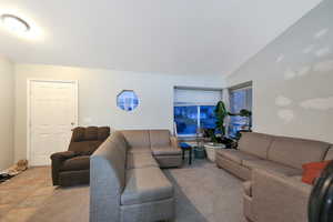 Living area with lofted ceiling and a textured ceiling