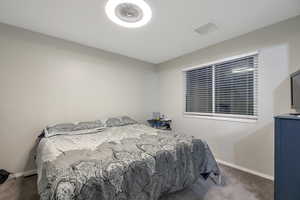 Bedroom featuring baseboards, visible vents, and carpet flooring