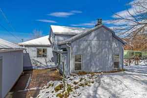 View of snow covered rear of property