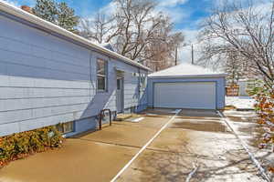 Exterior space with a garage and an outbuilding