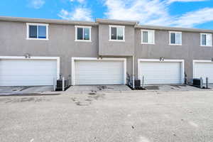 Exterior space with central AC unit and stucco siding