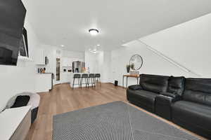 Living area featuring light wood-type flooring and recessed lighting