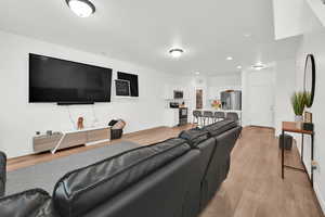 Living room featuring light wood-style floors, baseboards, and recessed lighting