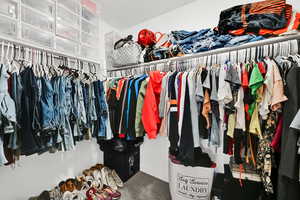Spacious closet featuring carpet flooring