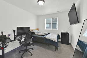 Bedroom featuring carpet, visible vents, and baseboards