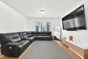 Living area featuring a textured ceiling and wood finished floors