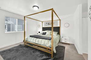 Carpeted bedroom with visible vents and baseboards