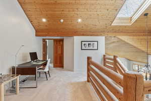 Office featuring high vaulted ceiling, a skylight, recessed lighting, wood ceiling, and carpet flooring