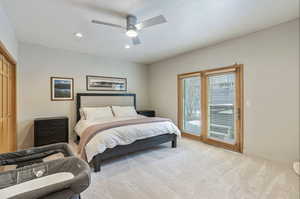 Bedroom with a ceiling fan, recessed lighting, baseboards, light colored carpet, and access to exterior