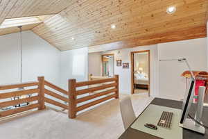 Interior space featuring lofted ceiling, wooden ceiling, recessed lighting, and carpet floors