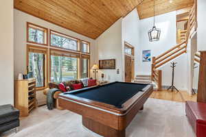 Playroom with carpet flooring, high vaulted ceiling, wood ceiling, and pool table