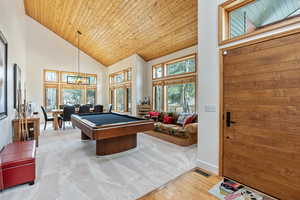 Rec room featuring billiards, baseboards, visible vents, high vaulted ceiling, and wooden ceiling