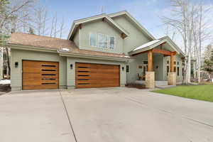 View of front of property with a garage and driveway