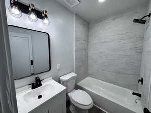 Bathroom with toilet, shower / tub combination, visible vents, and vanity